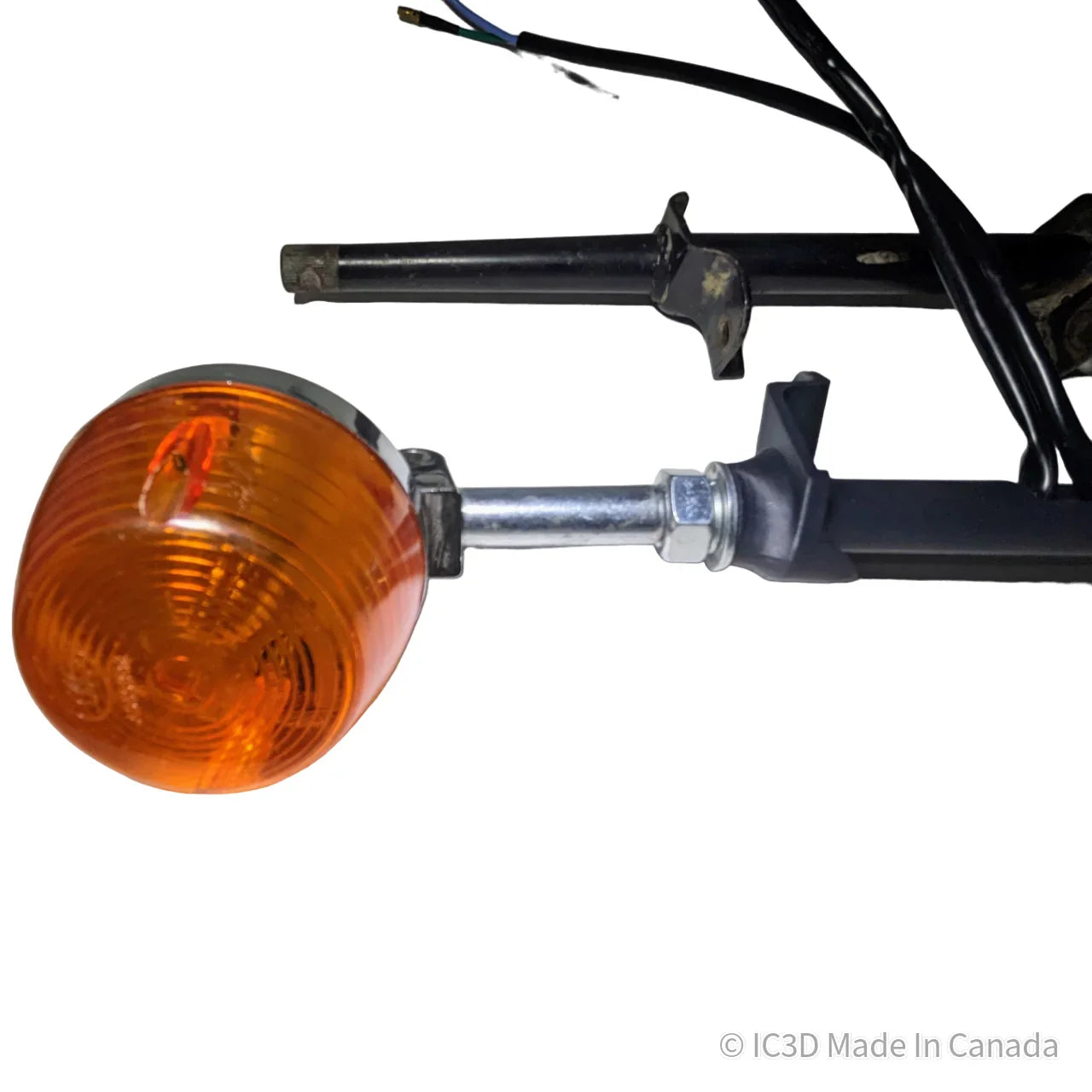 Motorcycle or scooter orange turn signal light assembly with wiring on a white background