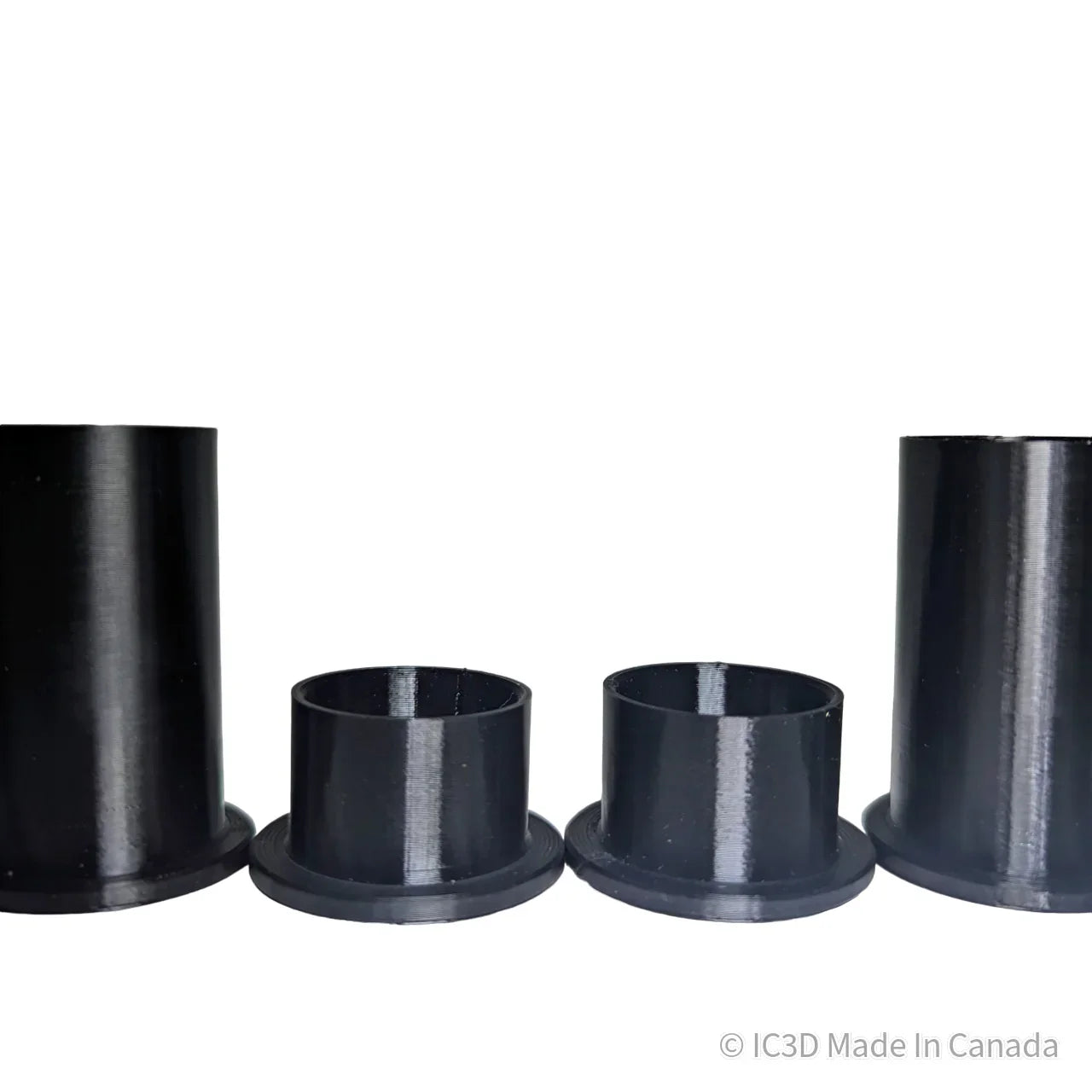 Set of four black 3D printed plastic pipe adapters with flanges on white background