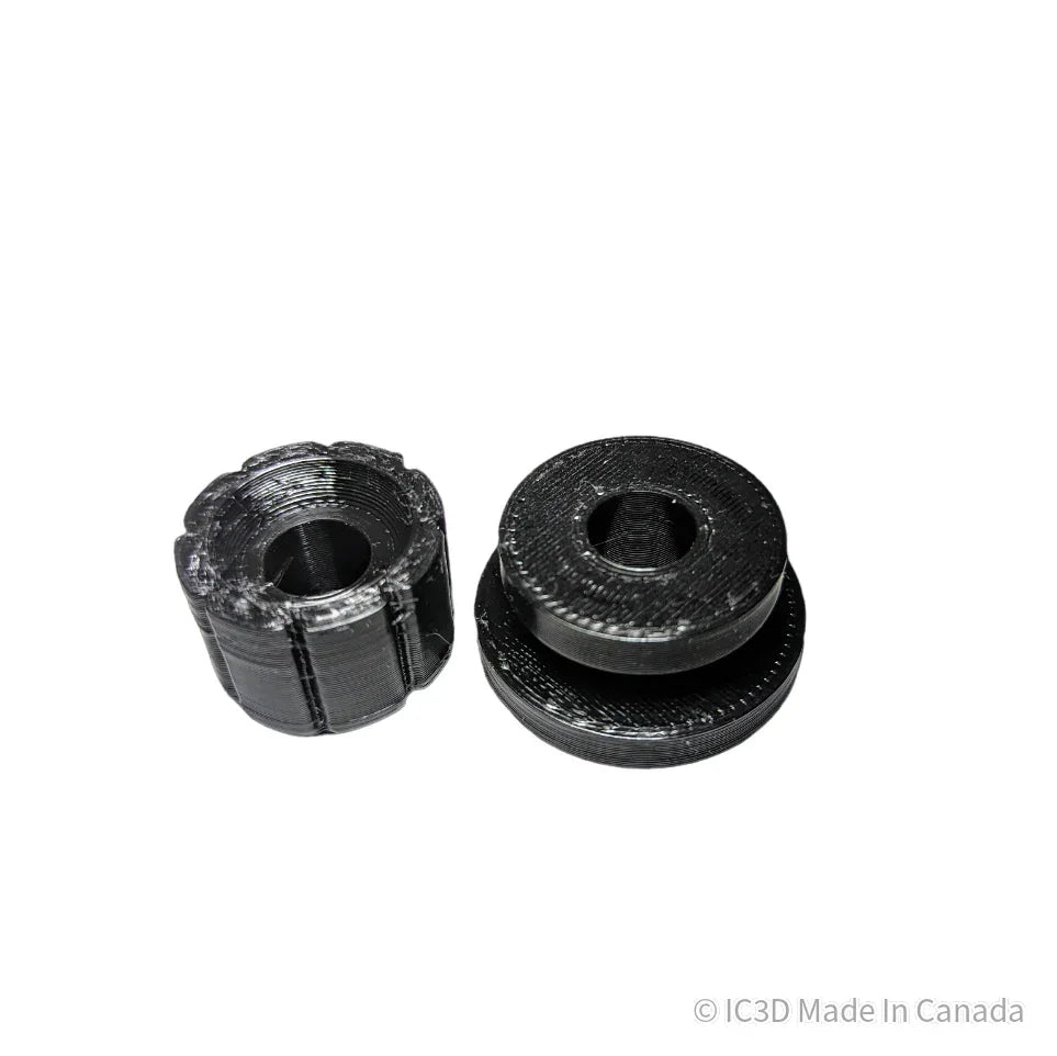Two black 3D printed plastic mechanical parts on a white background